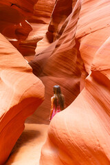 Young girl exploring Antilope Canyon in Arizona. Antilope canyon the most beautiful canyon in USA - obrazy, fototapety, plakaty