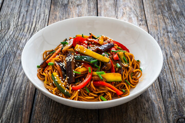 Korean style stir fried vegetables and noodles on wooden table
