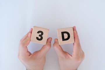 Man hands holding wooden cubes with 3D letters on them, three dimensional or design idea, wooden...