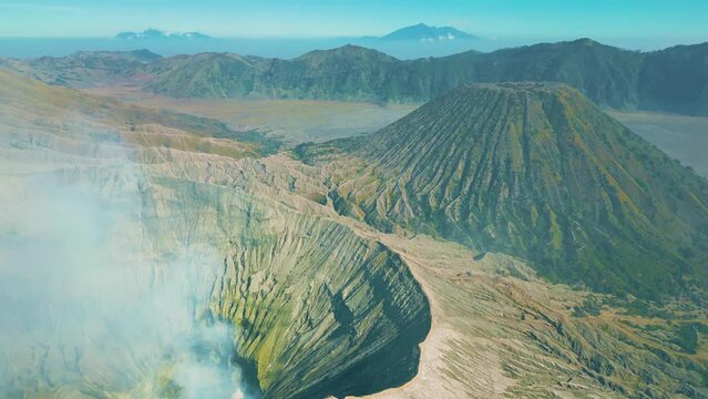 Dramatic view inside the crater and caldera of Mount Gunung Bromo an active somma volcano, Bromo Tengger Semeru National Park, East Java, Indonesia. Aerial drone view 4K.