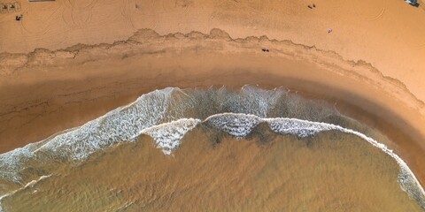 Arial shot of see meeting sand