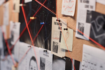Closeup background image of evidence board with red thread connecting pictures, copy space