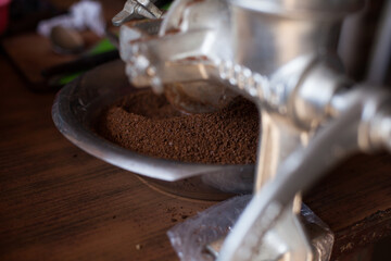Photo of ground coffee in a traditional mill in South America (Peru). Concept of food, beverages and traditions.