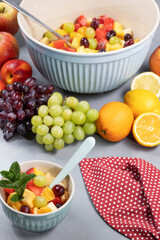 freshly prepared fruit salad in a large bowl and matching filled dessert bowl