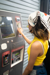 Unrecognizable young mexican woman paying her bus card. Integrated mobility.