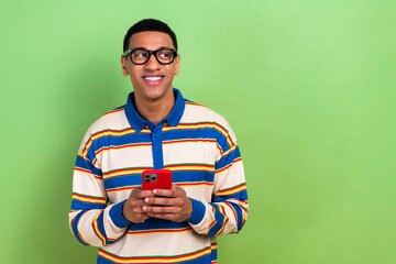 Photo of smiling email marketing specialist young guy with iphone look empty space ppc cost advert...