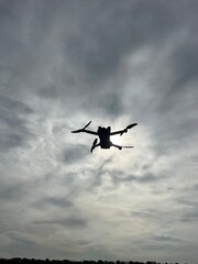 Naklejka na ściany i meble small drone flying drone against the sky