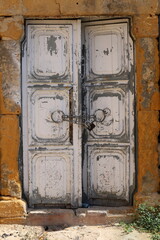 Entrance door to a building or structure. The texture of the material from which the doors are made.