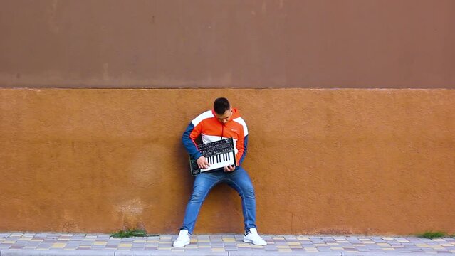 Guy playing wireless synthesizer close-up