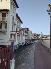 A row of white buildings next to a beach
