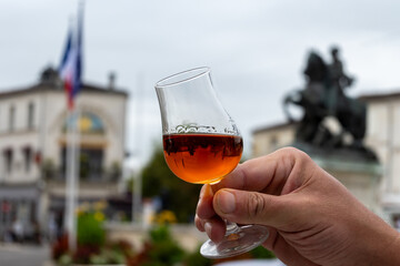 Tasting of Cognac strong alcohol drink in Cognac region, Charente with view on ols houses and...
