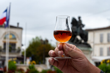 Tasting of Cognac strong alcohol drink in Cognac region, Charente with view on ols houses and...