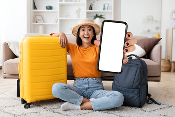 Excited young indian woman tourist showing phone with blank screen