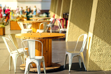 The table in restaurant is made of a large wooden wire spool