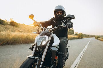 Man biker riding his motorbike on highway