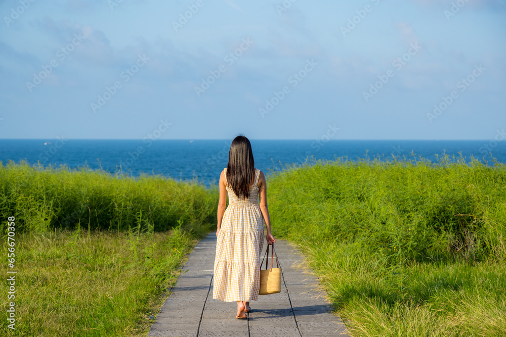 Wall mural Travel woman walk along the park in chaojing park in Keelung of Taiwan