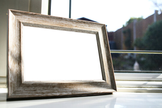 blank photo frame png mockup, on window ledge background, transparent centre