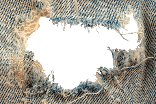 Hole in denim on a white background. Ripped jeans