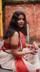 Portrait of beautiful Indian girl of Durga Idol Agomoni Concept Indoor Photo wearing traditional...