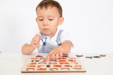 Bird eye view of preschooler, kindergarten boy playing with alphabet blocks