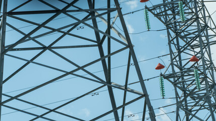 High voltage towers with sky background. Power line support with wires for electricity transmission. High voltage grid tower with wire cable at distribution station. Energy industry, energy saving