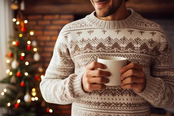 Schilderijen op glas man's hands in a knitted christmas sweater holding a white cup of coffee or cocoa © Маргарита Вайс