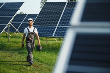 Worker installing solar panels outdoors.