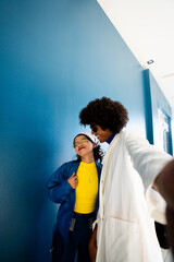 Afro mexican man taking selfie by looking his young woman friend