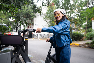 young mexican woman uncouples rented bicycle at Mexico City