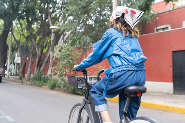 Unrecognizable young woman riding on a bike at the street on Mexico City