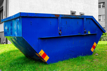 garbage container or bin on a grass. construction side.