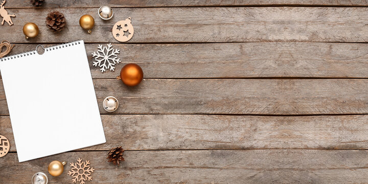 Blank calendar with Christmas decor on wooden background with space for text