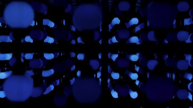 Futuristic video with alternating blue spheres that light up in a doppler effect. Technology corridor electric neon illumination led geometric wall. architecture interior cyber lines industrial 