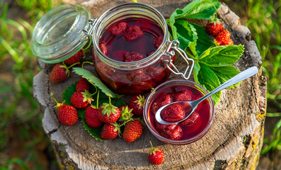 Strawberry jam in the garden. Selective focus.