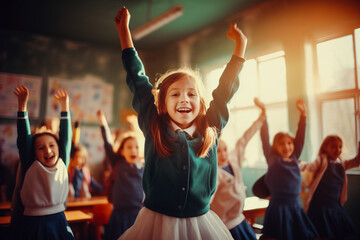 Playful elementary students jumping with raised arms in the classroom