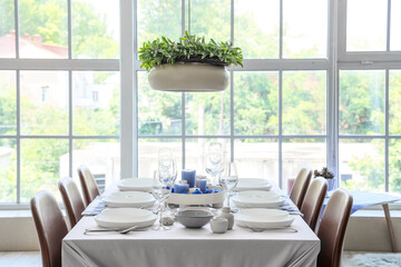 Festive table setting with burning candles and Christmas balls