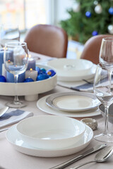 Festive table setting with burning candles and Christmas balls