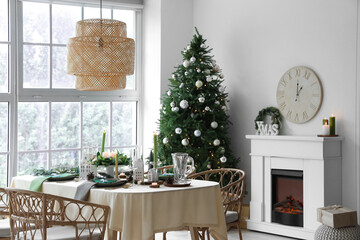 Festive table setting in living room with Christmas tree and fireplace