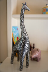 Small decorative metallic giraffe figurine on a table.