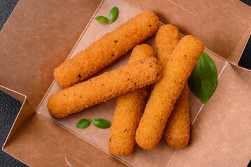 Delicious crispy cheese sticks with mozzarella, salt and spices, breaded and fried in oil