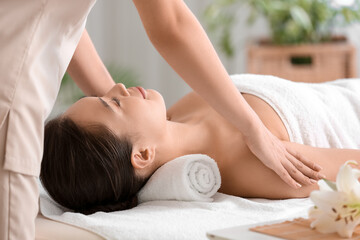 Obraz na płótnie Canvas Young woman having massage in spa salon, closeup