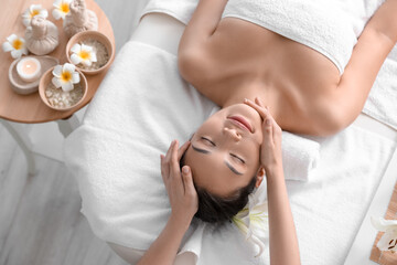 Obraz na płótnie Canvas Young woman having massage in spa salon, top view