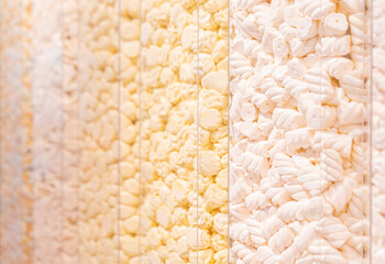 Pastel yellow marshmallows in a shop window. Food texture. Selective focus