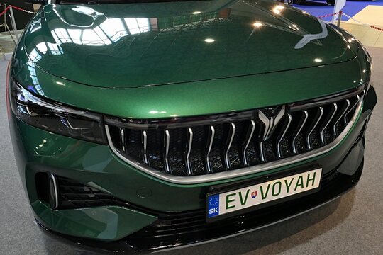 Elegant front mask of green metalic coloured modern chinese battery electric mid sized crossover SUV car Dongfeng Voyah Free EV, displayed on car expo in Nitra, Slovakia. 