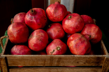 Fototapeta na wymiar Healthy pomegranate fruit in wooden box in the market.