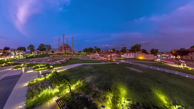 Evening falls over Edirne, Turkey, painting picturesque cityscape. Eski Ulu Old Mosque and Selimiye Mosque in Selimiye Park stand against twilight sky, accompanied by iconic Architect Sinan statue