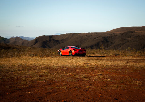 Red Ferrari 488 GTB on offroad cenario at Rola Mo&ccedil;a, Brazil. Rear angle view