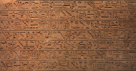Historical Egyptian symbols, drawings and symbols in the form of text on the wall.