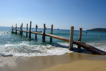 Crystal clear blue water of legendary Pampelonne beach near Saint-Tropez, summer vacation on white...