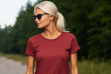 Portrait of a young woman in a red T-shirt against the background of a forest, radiant red